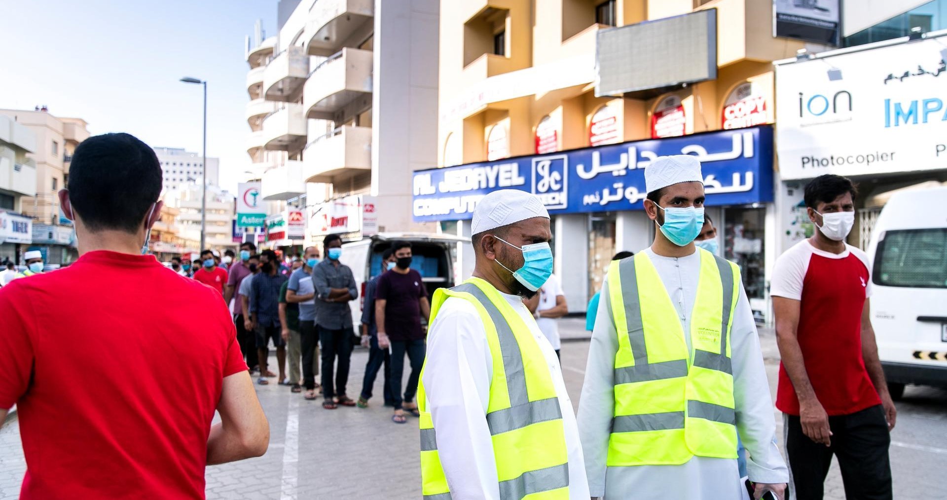 People line up in Bur Dubai to receive an iftar package